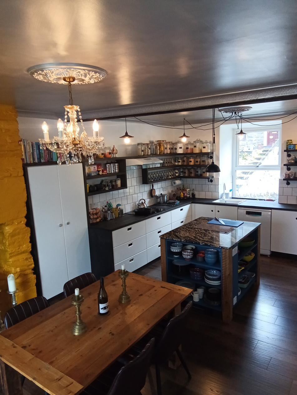 Hand painted kitchen with solid stained wood worktops and open shelving