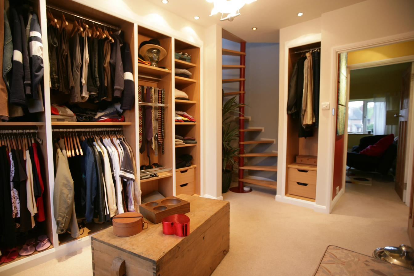 Walk in wardrobe with custom spiral staircase to loft bedroom